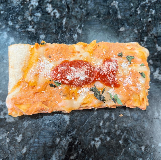 Baked Ziti Pizza Slice.