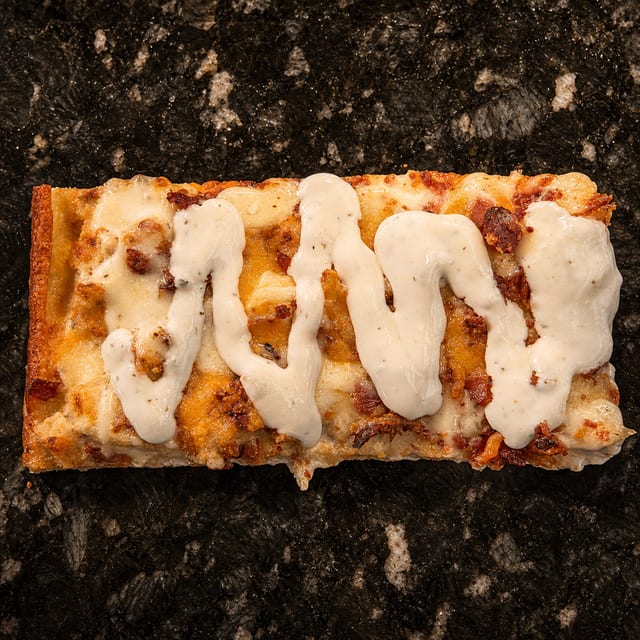 Bacon Chicken Ranch Pizza Slice.
